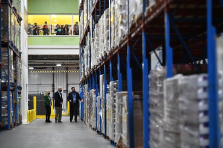 President Joe Biden and first lady Jill Biden, escorted by Houston Food Bank CEO Brian Greene, tour the facility on 26 February.