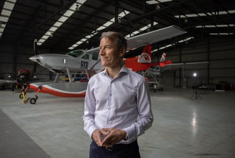 David Doral standing in a hanger in front of an electric aircraft