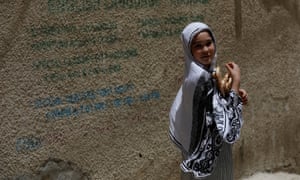 A girl carries naan bread in Hazara Town