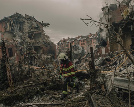 Firefighters work at the site of a Russian missile strike on a residential area in Kyiv