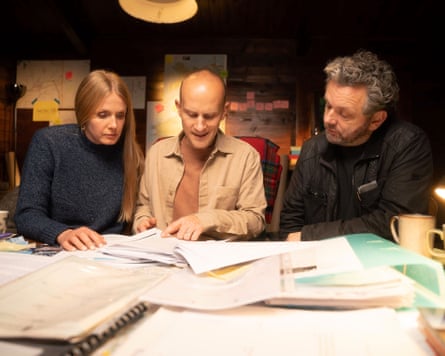 Lucy Taylor, Dan Ashby and Michael Sheen sitting at a desk looking at papers