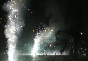 An Indian man lights firecrackers during Mumbai’s new year celebration