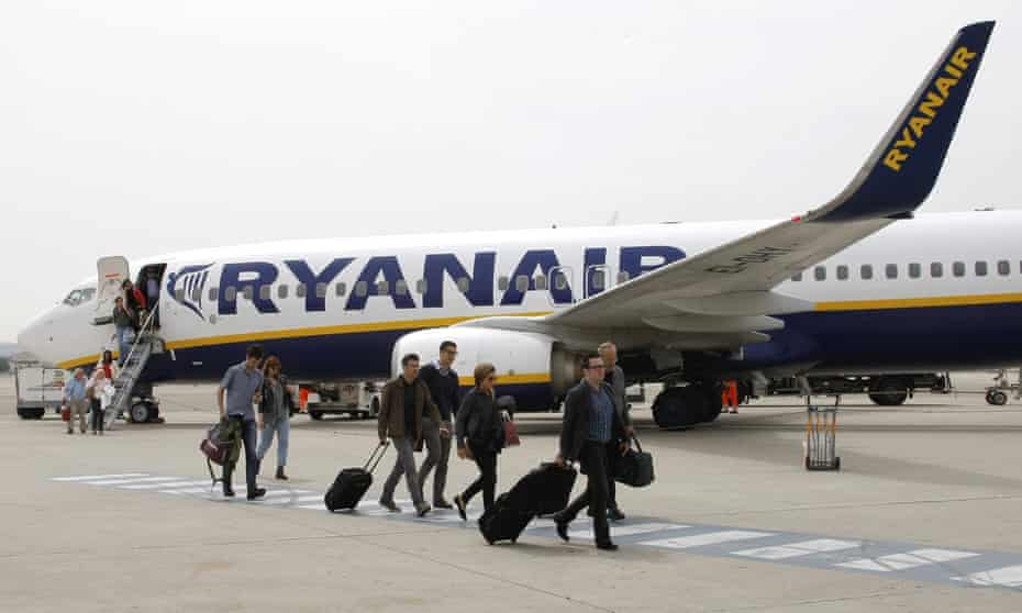Passengers disembark from a Ryanair plane