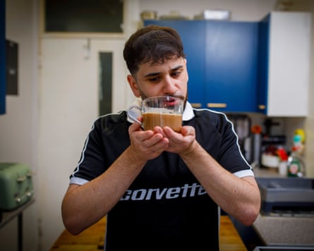 Sammy Gecsoyler sniffs a large mug of coffee