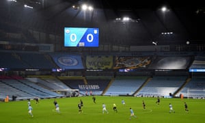 General view of the action on the pitch as the second half kicks off in front of empty stands.