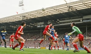 Wimbledon’s Lawrie Sanchez (centre) beats Liverpool central defender Gary Ablett to the ball and flicks a header past goalkeeper Bruce Grobelaar to open the scoring.