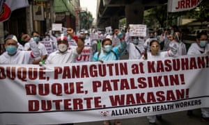 Healthcare workers protest outside the Department of Health in Manilla.