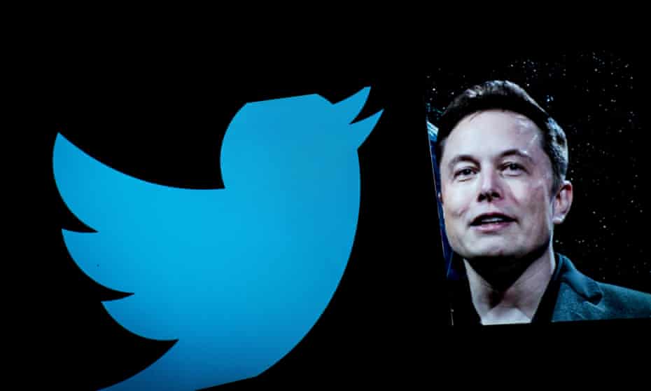 Elon Musk is seen displayed on a smartphone with a background of the Twitter logo