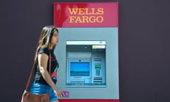 FILES-US-BANKING-CRIME-WELLSFARGO<br>(FILES) In this file photo taken on September 28, 2016 a woman walks past a Wells Fargo ATM in Pasadena, California. Wells Fargo will pay $1 billion in fines to address deficiencies identified by regulators in its mortgage and auto loan businesses, US regulators said April 20, 2018. The big US bank, which has been under fire from regulators and shareholders in the wake of a 2016 fake accounts scandal, will pay the fines to resolve actions brought by the Office of the Comptroller of the Currency and the Bureau of Consumer Financial Protection. / AFP PHOTO / FREDERIC J BROWNFREDERIC J BROWN/AFP/Getty Images