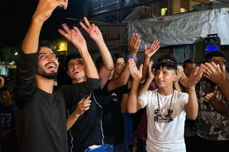 Palestinians celebrate in Khan Younis on after news of a new Gaza ceasefire deal.