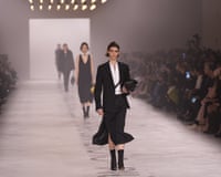 Models walk down the catwalk in black clothes at the Fendi Fall/Winter women's collection in Milan, Italy.