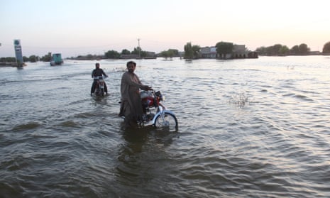 People in Pakistan’s Sindh province seek higher ground after flooding in October. 