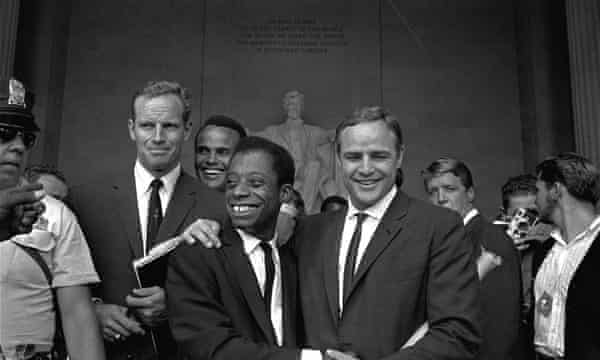 Actor Marlon Brando, right, poses with his arm around James Baldwin in front of the Lincoln statue at the Lincoln Memorial, August 28, 1963.