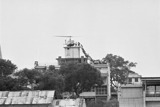 Evacuees mounting a staircase to board an American helicopter on the top of an apartment building near the US embassy in Saigon in 1975.