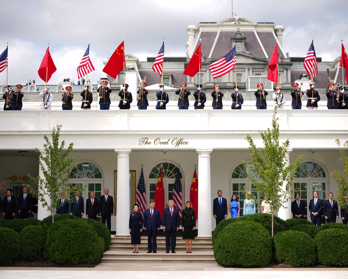 The leaders participate in a military review in the Rose Garden of the White House.