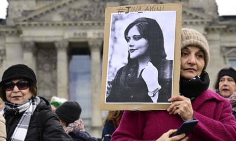 A woman holds a portrait of Mahsa Amini, a young Iranian woman who died after being arrested in Tehran by the Islamic Republic’s morality police, during a demonstration in front of the Bundestag in Berlin on International Women’s Day on Wednesday.
