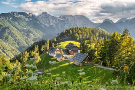 Houses on a hill surrounded by mountains