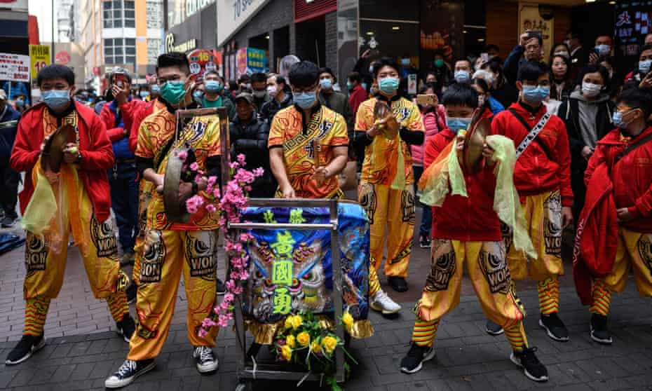 A Chinese lion dance team wear face masks during a performance in the Mong Kok district of Hong Kong. Health workers are set to go on strike over the government’s refusal to close the China border to contain the coronavirus outbreak.