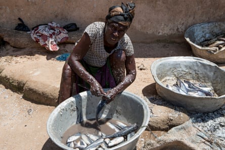In Nyanyano, a local fishmonger covered in scales prepares fish caught earlier that morning. Protein is rare in Ghana and usually reserved for consumption by male household heads