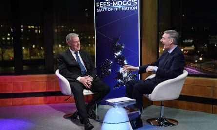 Anderson and Rees-Mogg face each other seated in chairs for a TV chat