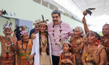 Man in pink shirt with Jivi tribe members