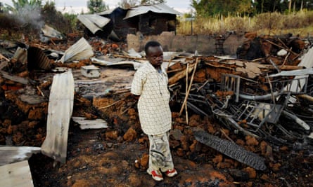 A child stands amid the ruins of a church that was burned to the ground killing 18 people during violence after Kenya’s 2007 election.