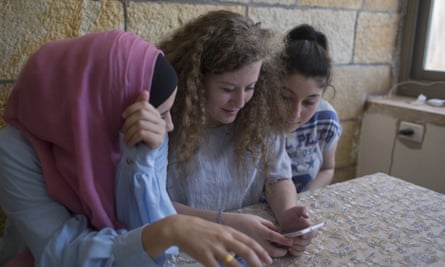 Ahed Tamimi, centre, with her friends at the family home in the West Bank village of Nabi Saleh.