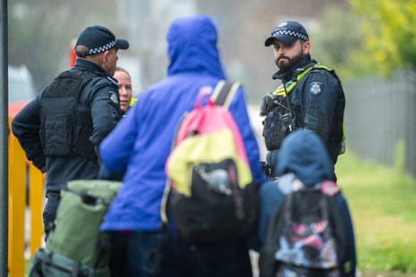 Police supervise the arrival of students at Porepunkah State School