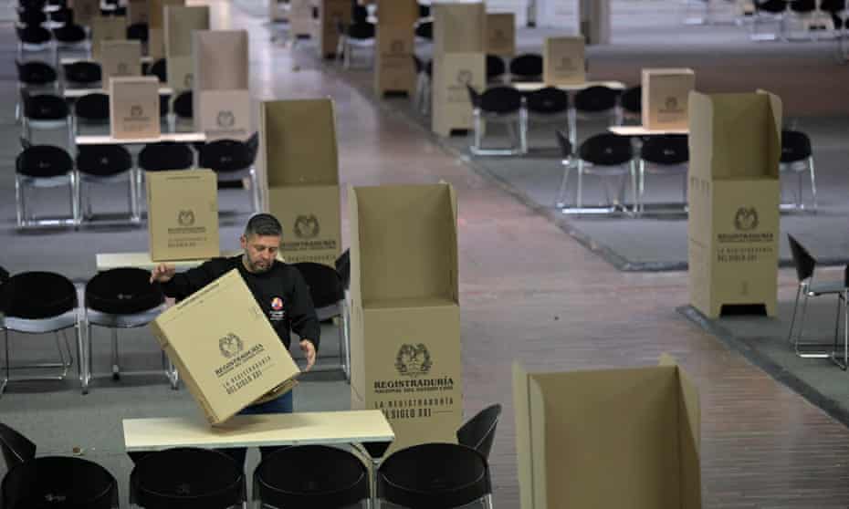 A worker helps prepare a polling station in Bogota ahead of the weekend's presidential runoff election.