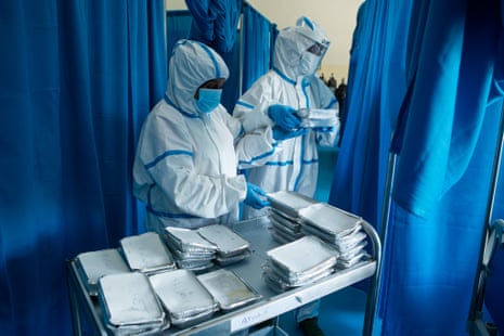 Two nurses serve lunch to patients at the treatment ward of the De Martini hospital.