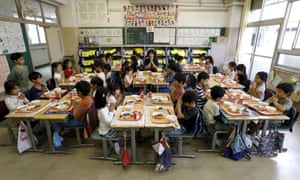 First grade students and teacher Teruko Takakusaki give thanks at Takinogawa elementary school