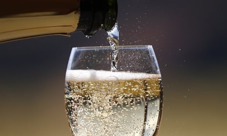 A glass of sparkling wine being poured