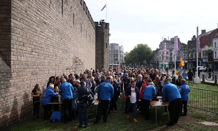 People queue to get into a proclamation ceremony for King Charles III at Cardiff Castle in Cardiff, Wales.