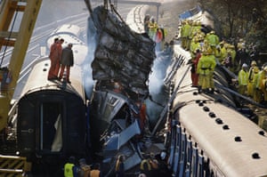 Firefighters and police work after a rail crash