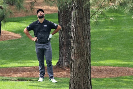 Jon Rahm reacts after hearing the hooter for the suspension of play.