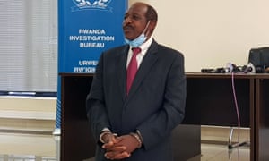 Paul Rusesabagina is detained in front of media in handcuffs in Kigali, Rwanda.