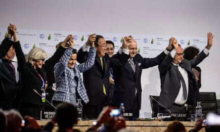 Participants join hands as they stand to celebrate