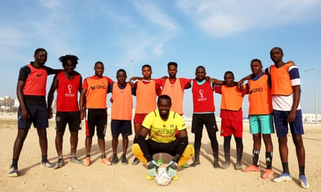 Coach Robert Otiato (centre, crouched) with his Mazrouah FC players.