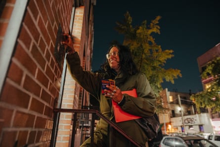Cynthia, 37, a first-time canvasser and voter supporting Mamdani, knocks on the door of an apartment building in Bushwick the week before the mayoral election.