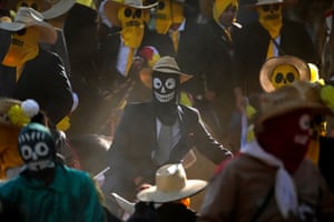 People wear skeleton masks at the Cavalhadas festival