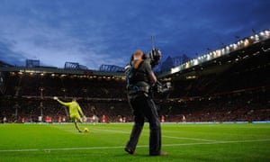 A TV cameraman films a match.