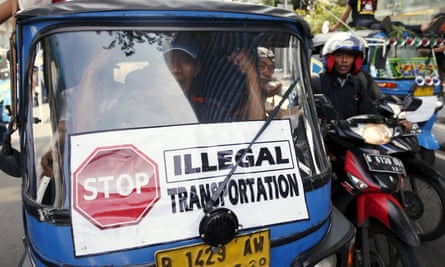 A traditional bajaj taxi takes part in a protest rally for ban on online taxi apps in Jakarta.