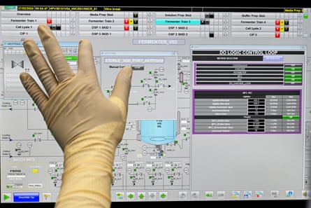 A hand in a surgical glove at a computer screen