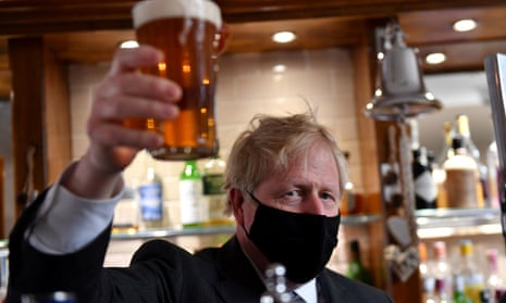 Boris Johnson holds up a beer during a visit to The Mount Tavern Pub and Restaurant on the local election campaign trail in Wolverhampton, last April.