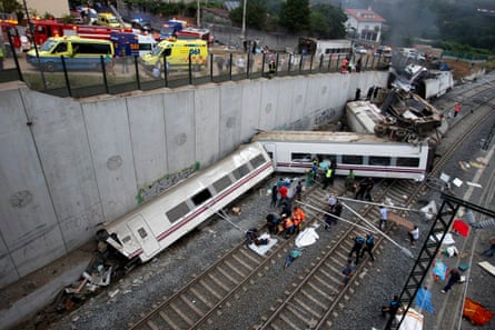 Rescue workers help passengers from two derailed carriages