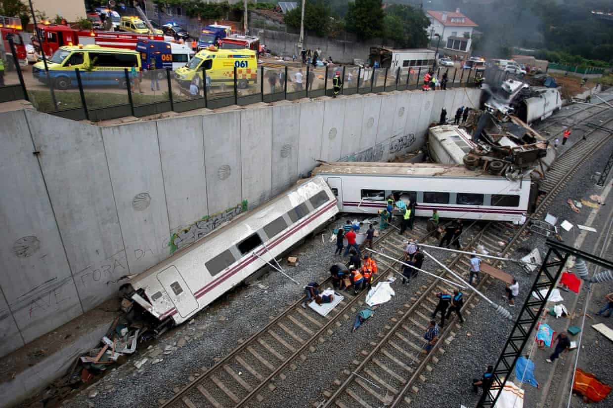 Rescue workers help passengers from two derailed carriages