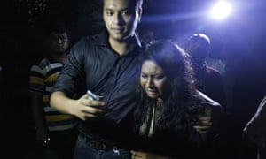 An unidentified colleague of Xulhaz Mannan weeps as she leaves the crime scene in Dhaka.