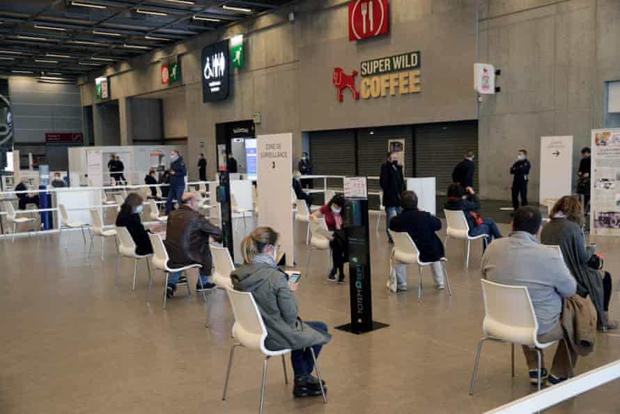 People wait at a vaccination centre set up at the Porte de Versailles convention centre in Paris, on 15 May, 2021.