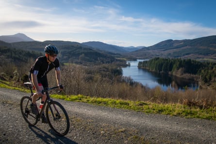 Biking on gravel path in mountainous scenery.