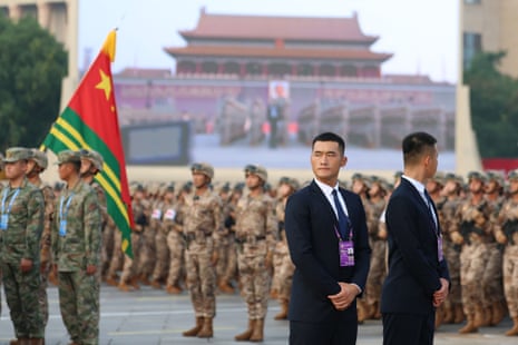 Security guards observe a rehearsal prior to the military parade
